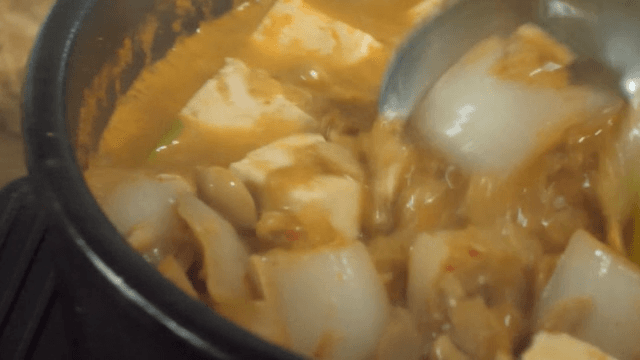 Soy Bean Paste Stew in Earthen Pot Placed on a Wooden Table