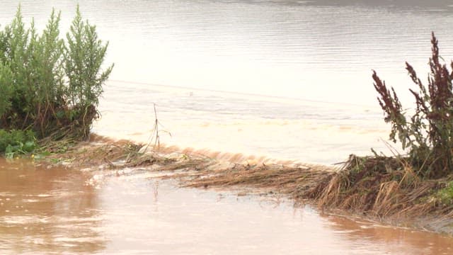 River overflowing all the way to the road