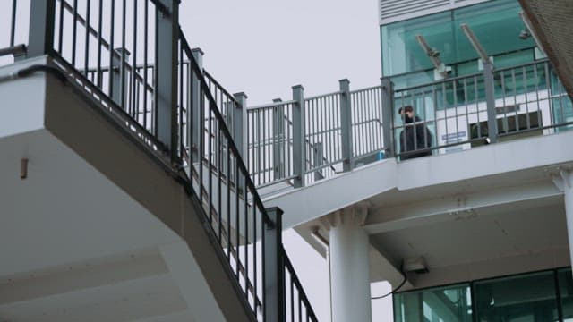 Person walking on a modern pedestrian overpass