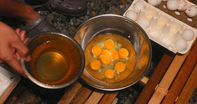Cooking eggs in a bowl at a camping site