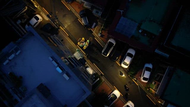 Street cleaners disposing of trash in the urban alleys