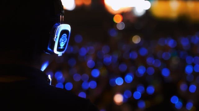 Person wearing illuminated headphones at night party