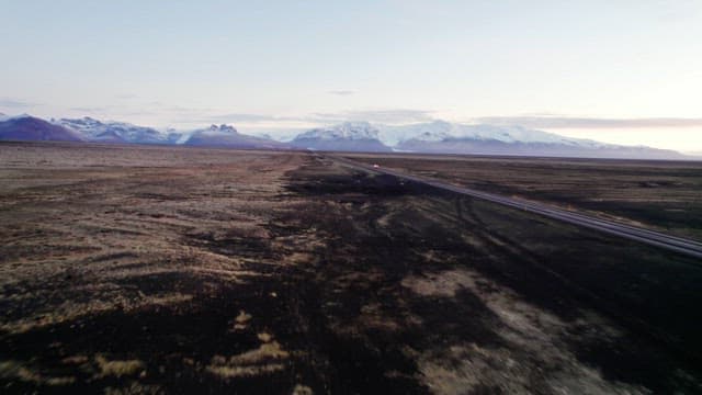 Vast landscape with distant snowy mountains
