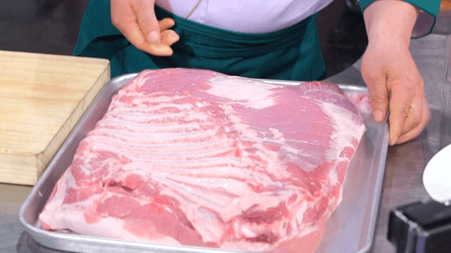 Whole pork belly on a tray