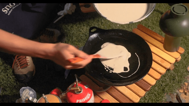 Preparing Vegetable Pancakes Outdoors at Night during Camping