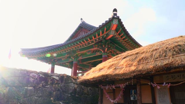 Traditional Korean house with thatched roof and historic structure