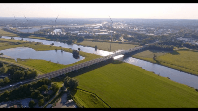 Bridge over a river with wind turbines