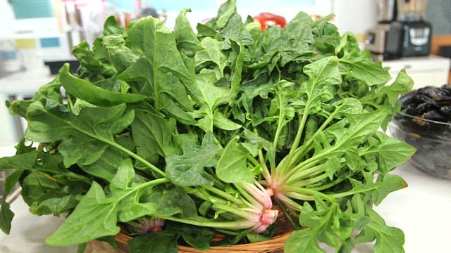 Fresh spinach leaves in a basket