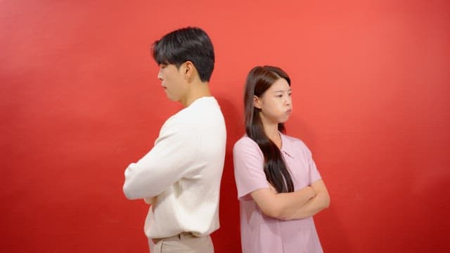 Man and a woman turning their backs on each other after an argument