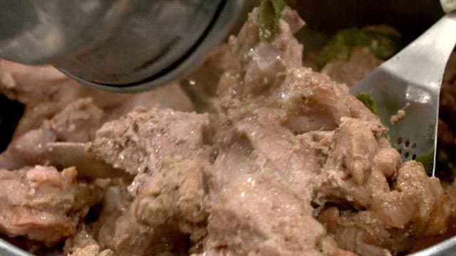 Pork ribs and peppers boiled in a pot