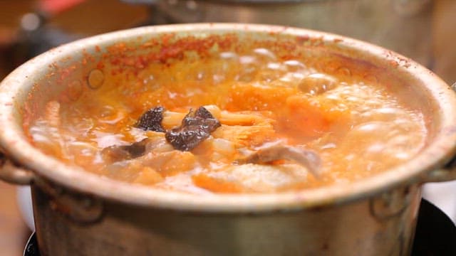 Codfish soup boiling in a pot