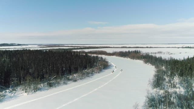 Snowmobiles Trailblazing through Snowy Landscape