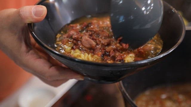 Appetizing ramen with bacon in a black bowl