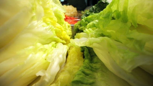 Fresh leafy greens and vegetables on display in a market stall