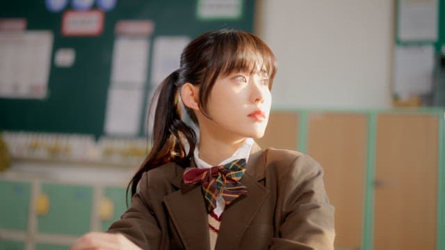 Student in a classroom with sunlight