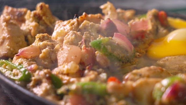 Hearty dish with vegetables, meat, and eggs