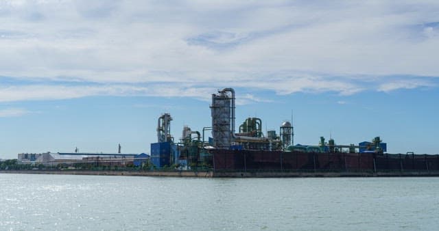 Industrial plant near the sea under blue sky