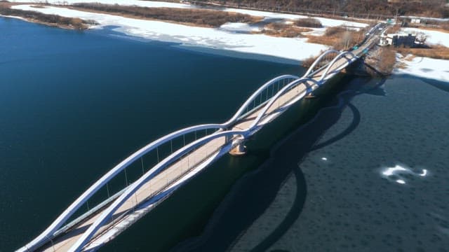 Aerial View of a Bridge over a Partially Frozen River