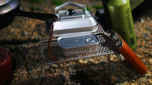 Preparing an outdoor meal with camping cookware