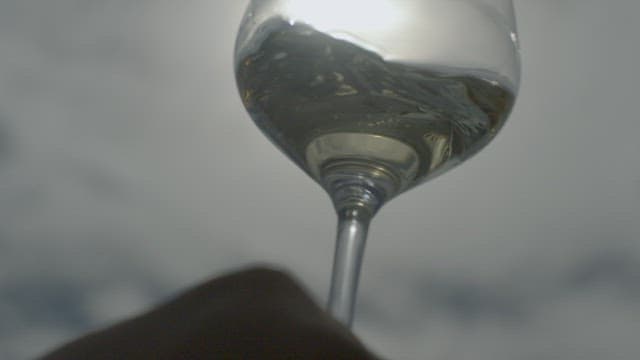 Motion of Water Shimmering in a Glass with Sunlight