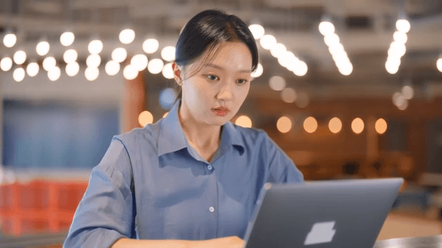 Woman working on a laptop in a modern office