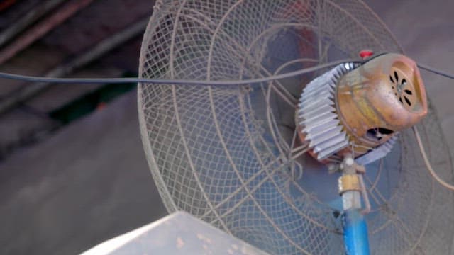 Old industrial fan with metal cage