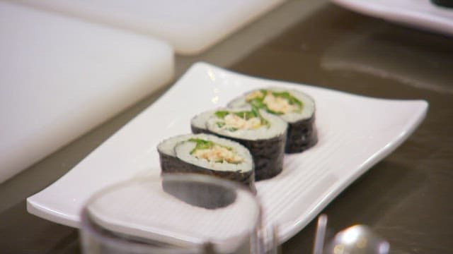 Delicious crab meat gimbap neatly plated on a white plate