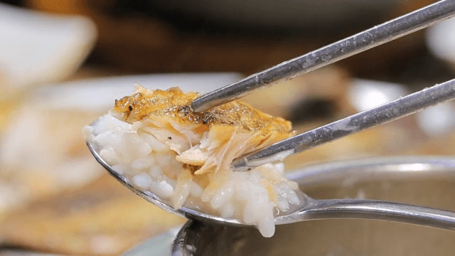 Grilled fish and rice on a spoon
