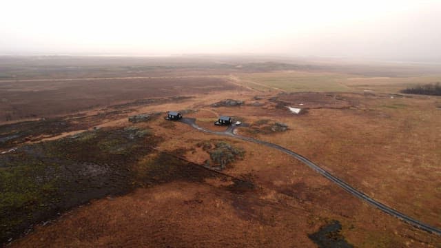 Remote cabins in a vast open landscape