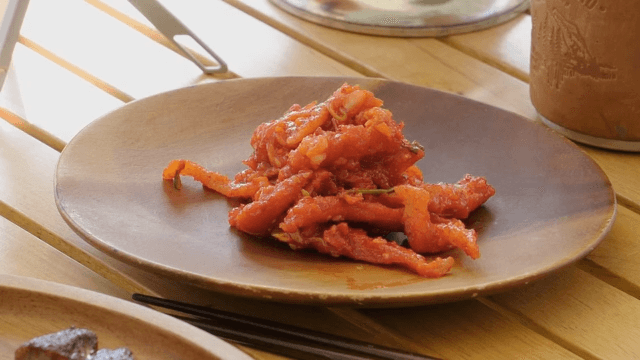 Radish kimchi plated on a wooden plate