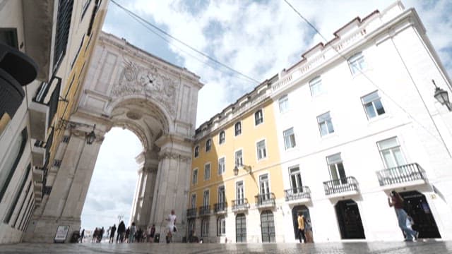 Historic Arch Gate with Blue Sky and Clouds in the Background