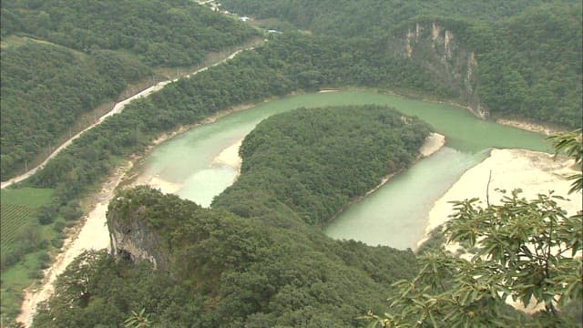 Aerial View of Serene Donggang River Meandering Through Lush Landscape