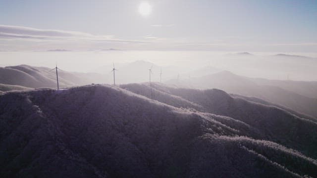 Wind turbines on Foggy Mountain Hill in the Morning