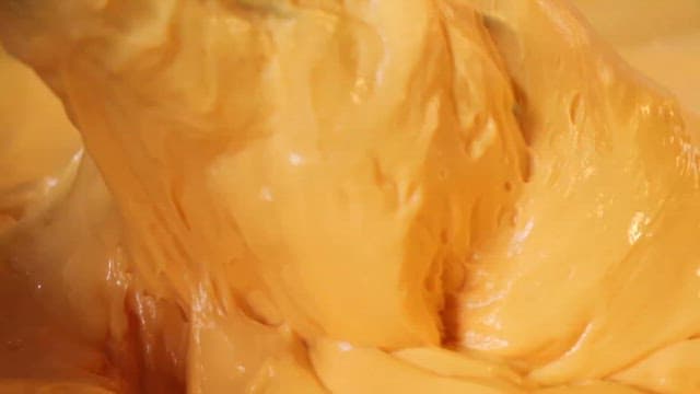 yellow cream mixed with a whisk