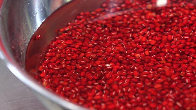 Red beans soaking in a metal bowl