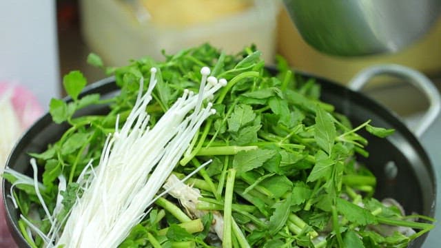 Broth Being Poured into a Pot with Vegetables