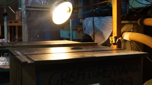 Lamp goes out in a workshop with tools and workbenches illuminated by bright light