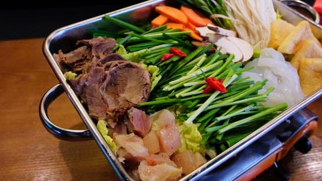 Fresh vegetables and meat prepared in a pot for tendon hotpot cooking