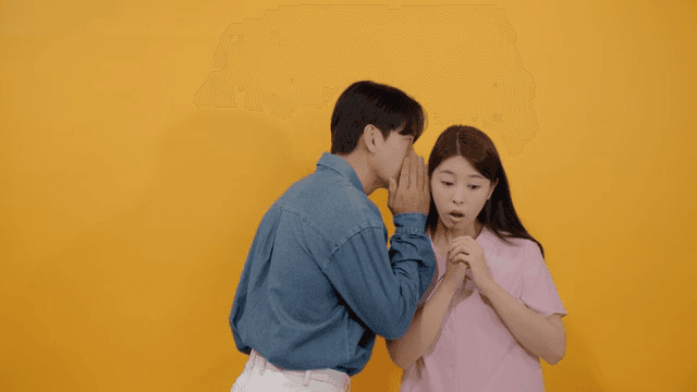 Man and a woman whispering quietly with serious faces