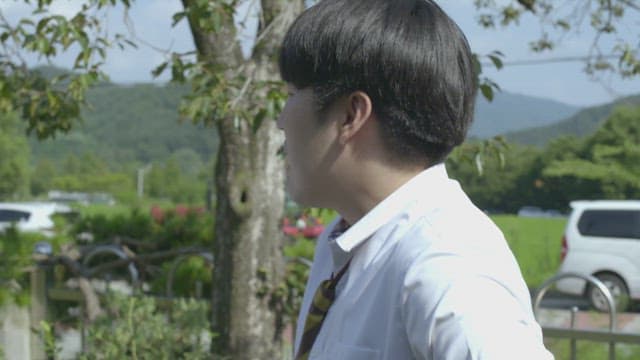Student wearing school uniform and talking to friend on a sunny day