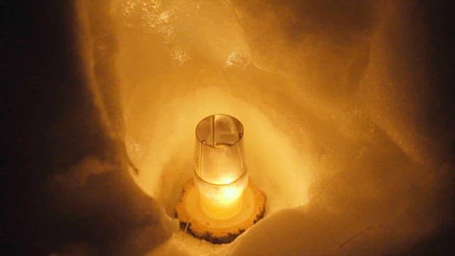 Candle Illuminating a Snowy Nook