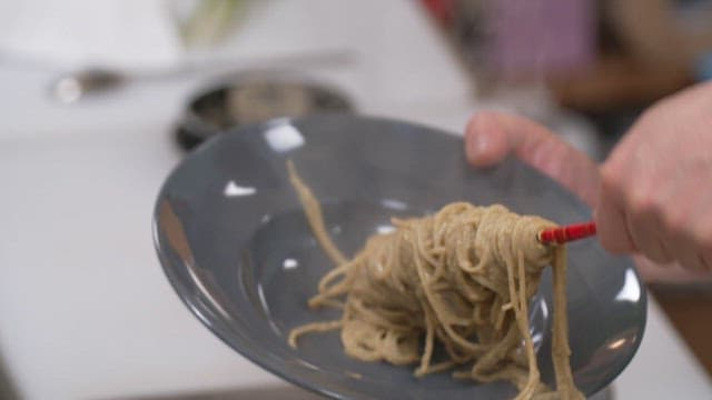 Serving freshly made pasta in a kitchen