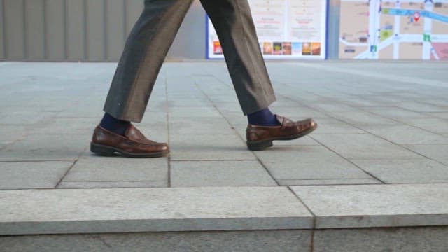 Close-up of a person walking in urban setting