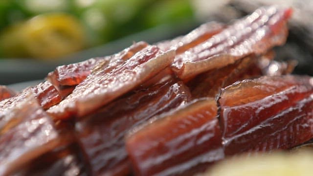 Glossy surface of neatly stacked fresh half-dried saury