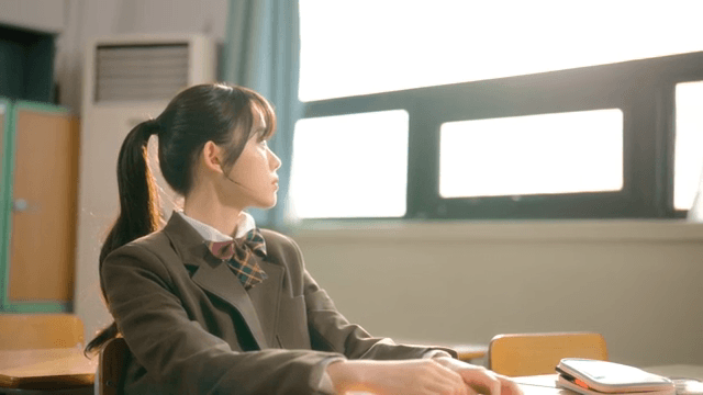 Student resting at a classroom desk