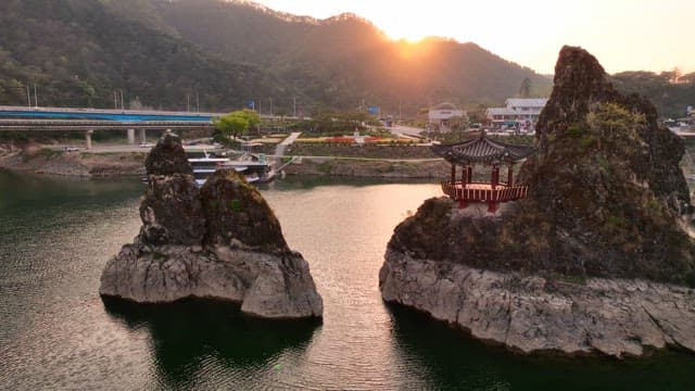 Traditional pavilion on rocky cliffs at sunset