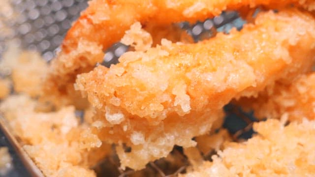 Close-up of crispy golden tempura frying