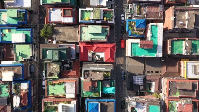 Colorful neighborhood with various rooftops in the afternoon