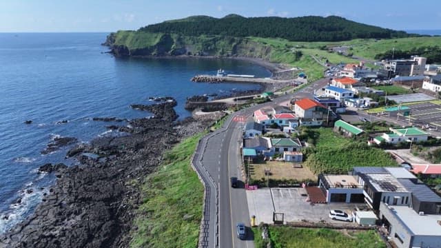 Coastal village with scenic road along rocky shore
