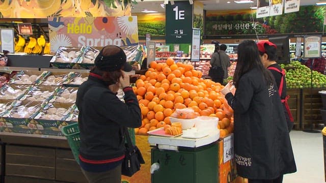 Choosing Fruit in the Fruit Section of a Supermarket